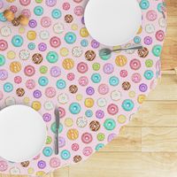 Scattered Rainbow Donuts on pale pink spotty - medium scale