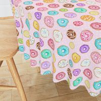 Scattered Rainbow Donuts on pale pink spotty - medium scale