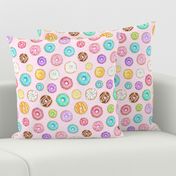 Scattered Rainbow Donuts on pale pink spotty - medium scale