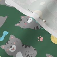 Playful gray kittens on green