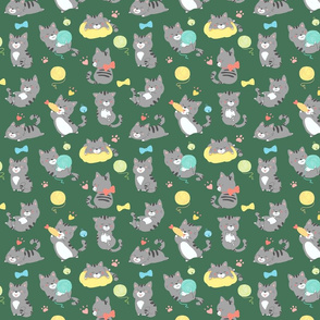 Playful gray kittens on green