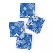 Paper snowflakes and stars on indigo background