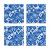 Paper snowflakes and stars on indigo background