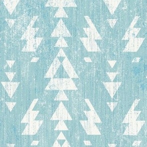 aztec geo with spark on light blue linen