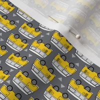 rotated tiny yellow mini-vans-side-view-on-charcoal