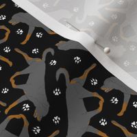 Tiny Trotting undocked Rottweiler and paw prints - black