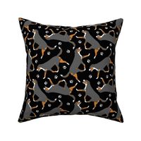 Trotting tailed Entlebucher mountain dog and paw prints - black