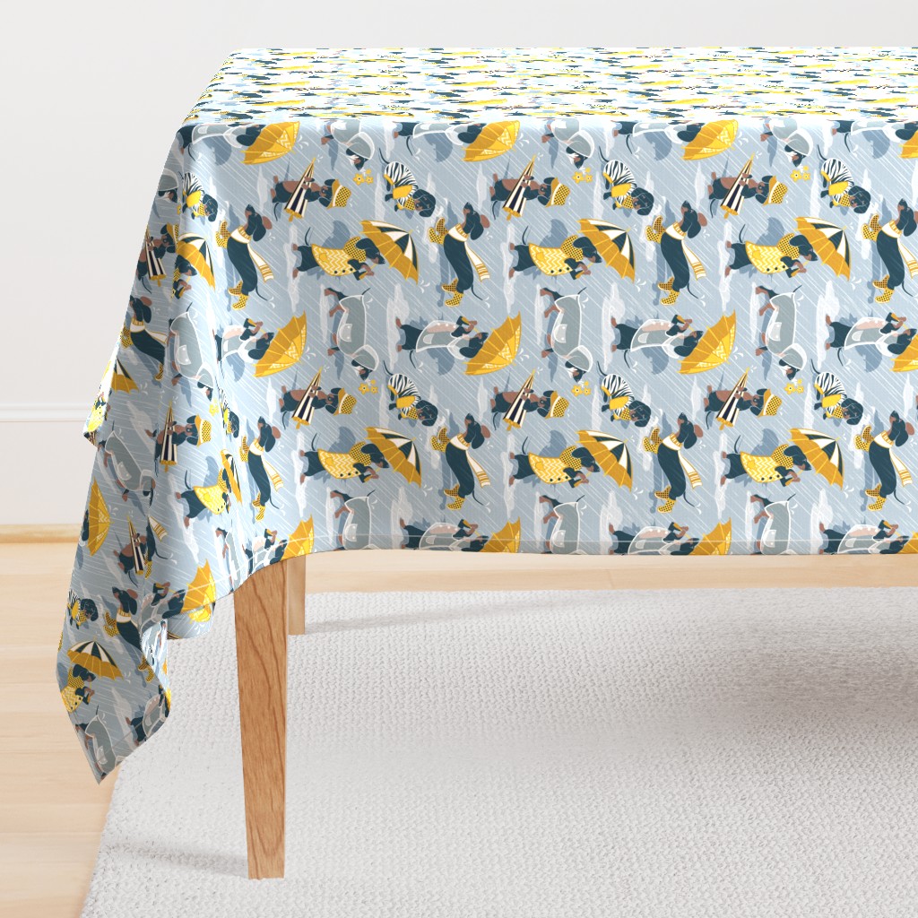 Small scale // Ready For a Rainy Walk // pastel blue background navy blue dachshunds dogs with yellow and transparent rain coats and umbrellas 