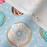 Rainbow Scattered Donuts on spotty pale blue - medium scale