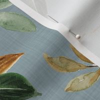 magnolia leaves and branches on blue linen