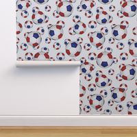 Red white and blue soccer balls on white - large