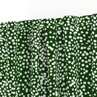 White dots on forest green