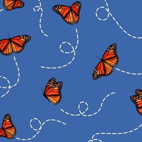 breezy floating Monarch butterflies on blue