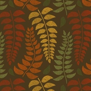 leaf fronds in fall colors on brown