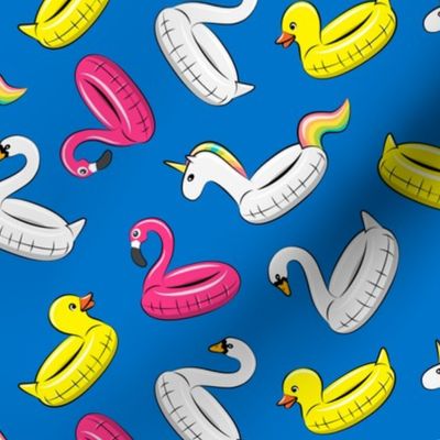 pool floats (swan, flaming, duck, unicorn) on blue