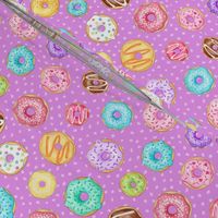 Scattered Rainbow Donuts on bright purple spotty