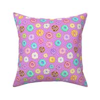 Scattered Rainbow Donuts on bright purple spotty