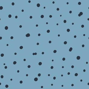 Hand drawn black polka dot on blue background