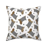 Trotting Yorkshire Terriers and paw prints - white