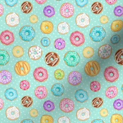 Scattered Rainbow Donuts on mint spotty - small scale