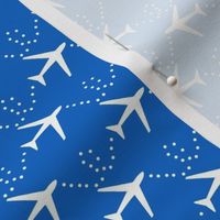 Airplanes in the sky:  white planes on cobalt blue background