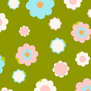 White, blue and pink flowers over green background