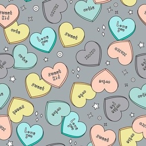 Candy hearts on grey