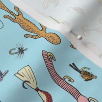 Fishing lures on blue tea towel