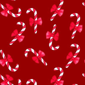 Candy canes with bow on red/ burgundy