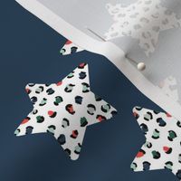 Leopard print stars seasonal Christmas ornaments december palette animal print navy red green