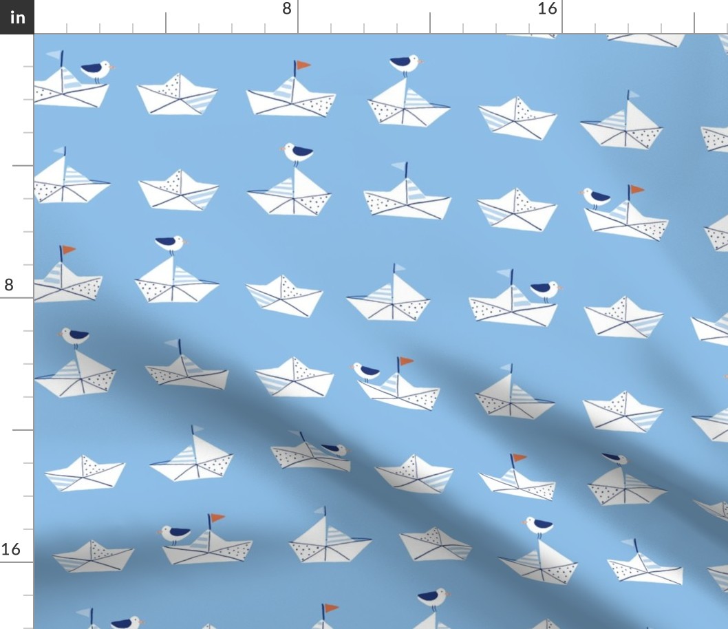 Paper boats in blue