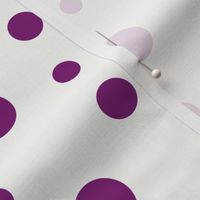 Purple dots of different sizes over beige background