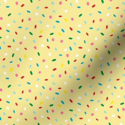 glazed with colorful sprinkles on yellow melting icing seamless pattern