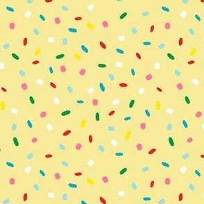 glazed with colorful sprinkles on yellow melting icing seamless pattern