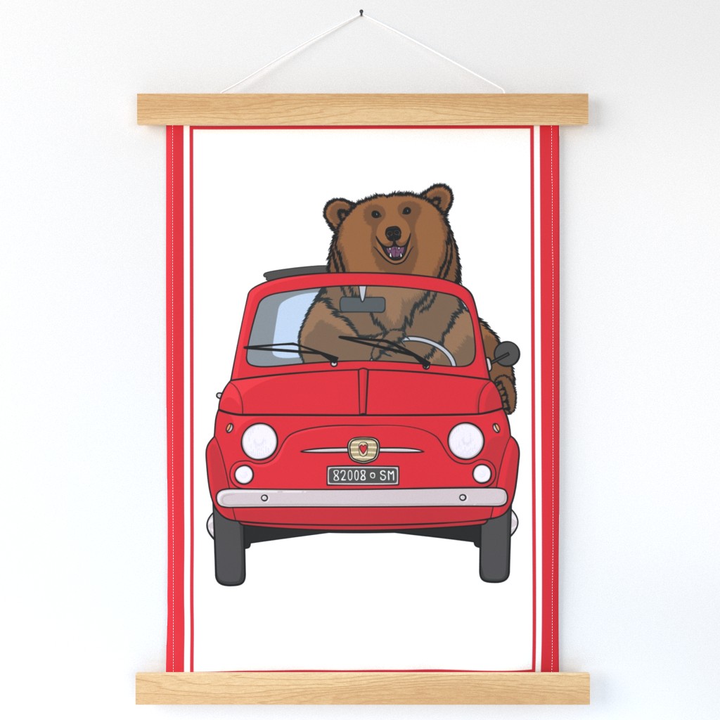 Big brown bear in a red car