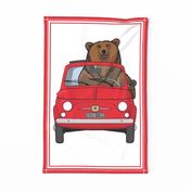 Big brown bear in a red car