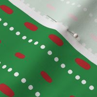 Christmas vector red and white vertical stitches aligned on green background, seamless pattern
