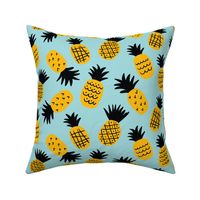 Cute hand drawn pineapples on light-blue background