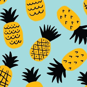Cute hand drawn pineapples on light-blue background