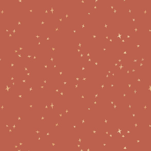 Scattered gold metallic stars on rouge red