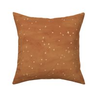 Scattered gold metallic stars fabric textured in copper