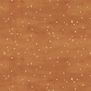 Scattered gold metallic stars fabric textured in copper