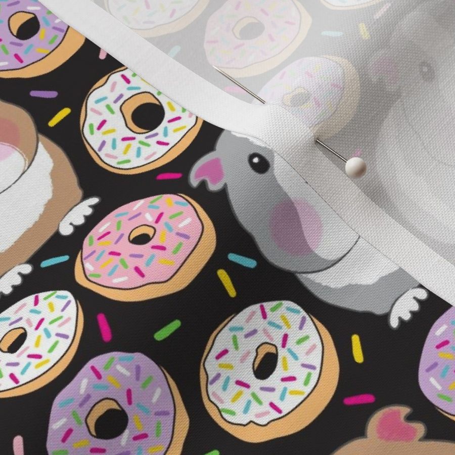 guinea pigs and white purple pink sprinkle donuts on black