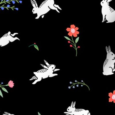 Cute bunnies on a flower field