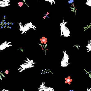 Cute bunnies on a flower field