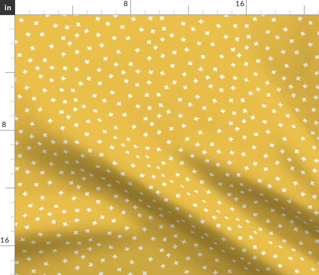 Geometric white cross stars on mustard yellow