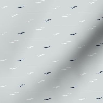 Tiny white and navy seagulls on cool grey