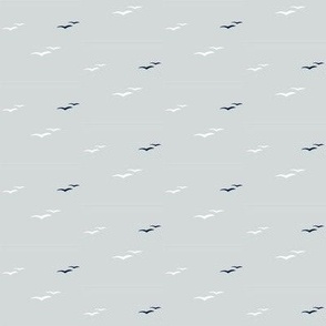 Tiny white and navy seagulls on cool grey