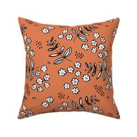 Delicate flower garden and lush green autumn leaves and poppy seeds orange rust