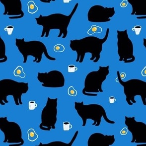Breakfast black cats. Coffee cups and fried eggs.